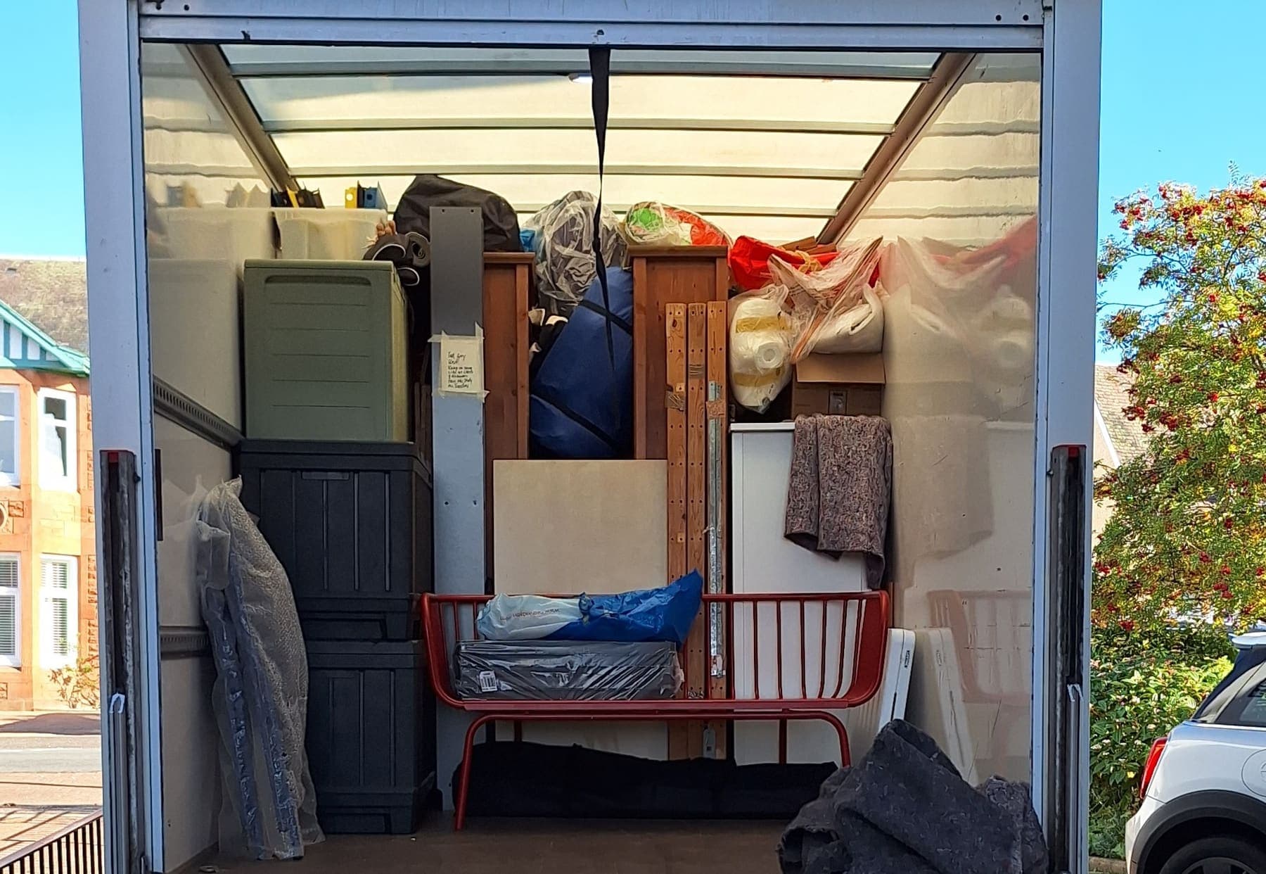 The back of a TransScot van loaded with furniture, boxes and protected items
